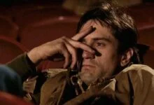 robert deniro as travis bickle with fingers over his eyes in a scene from taxi driver