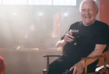 anthony hopkins with a cold brew coffee in a locker room
